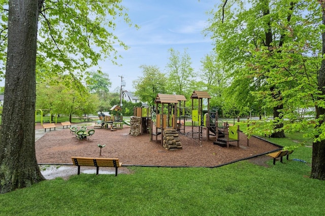 community jungle gym featuring a lawn