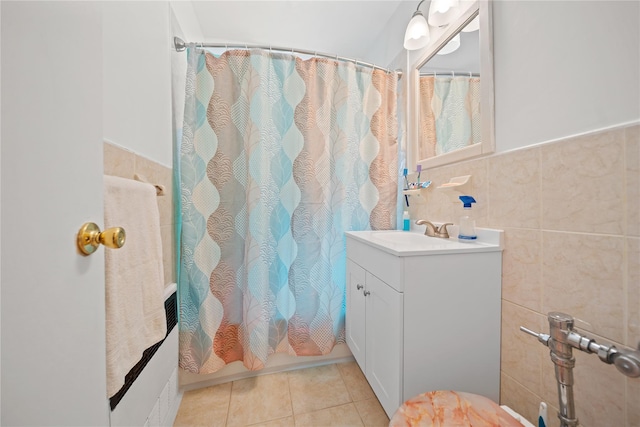 bathroom with vanity, tile patterned floors, a wainscoted wall, tile walls, and a shower with curtain