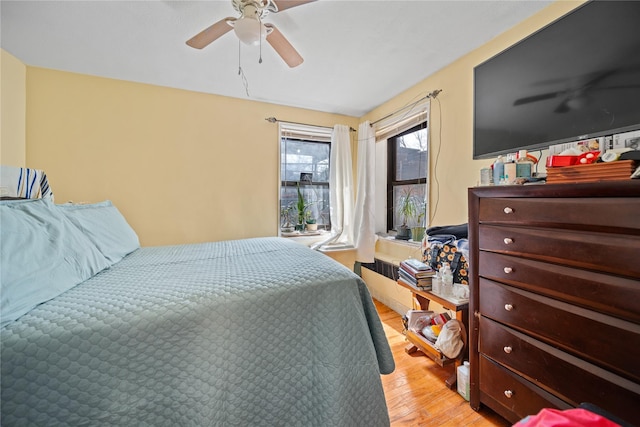 bedroom featuring light wood-style floors and ceiling fan