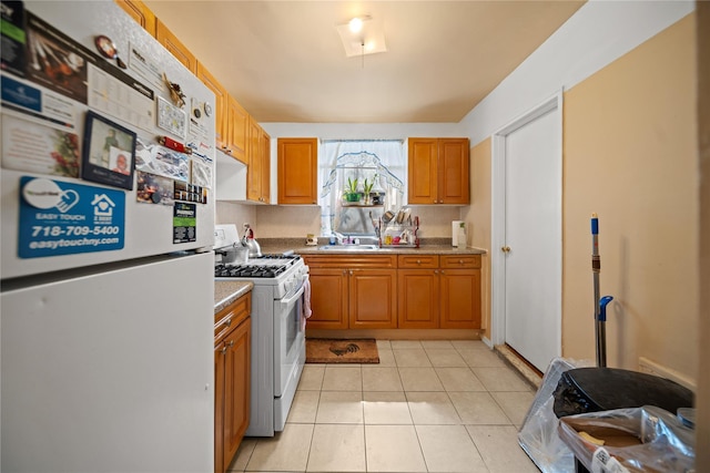 kitchen featuring a sink, white appliances, light countertops, brown cabinetry, and light tile patterned floors