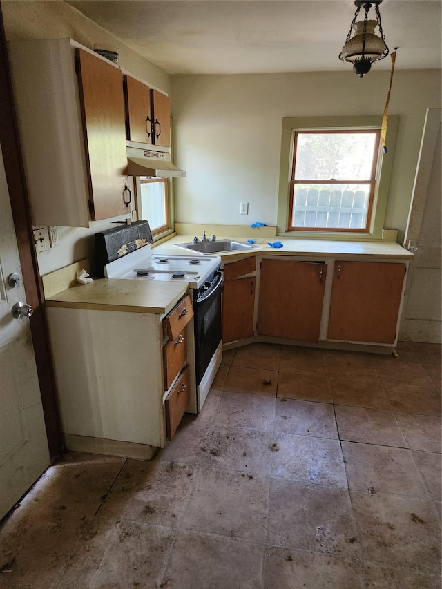 kitchen featuring light countertops, a sink, range with electric stovetop, and under cabinet range hood