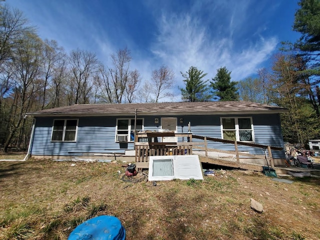 back of house with a deck