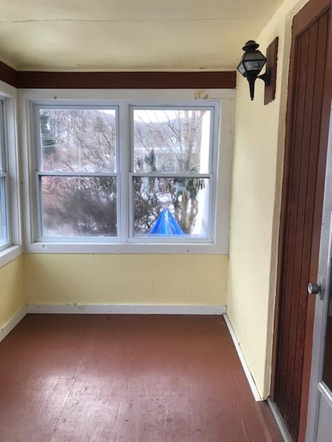 spare room with dark wood-style flooring and baseboards