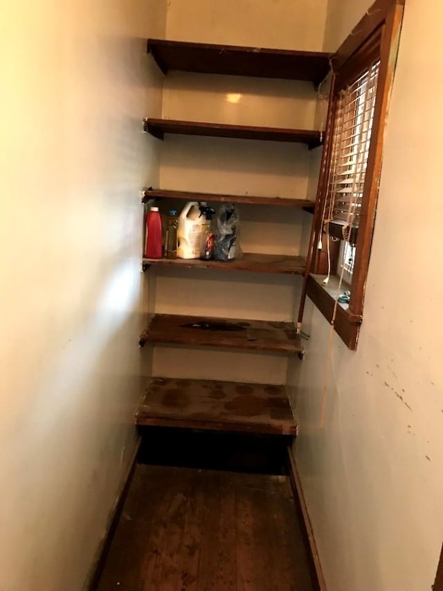 stairway with baseboards and wood finished floors