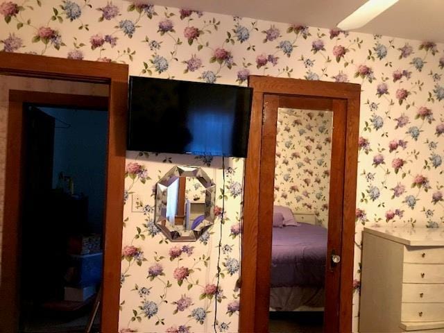 bedroom with wallpapered walls