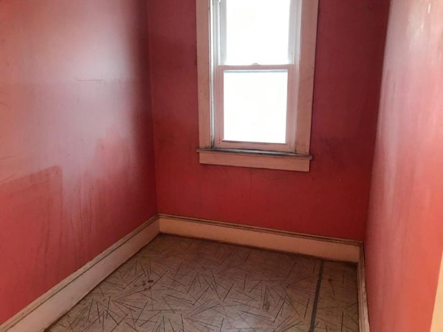 unfurnished room featuring baseboards
