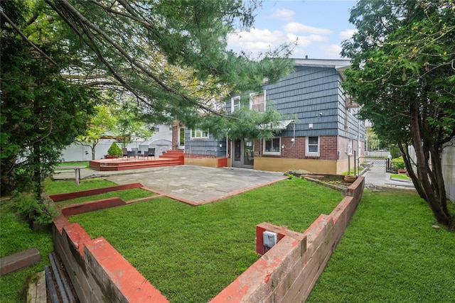 211 Cantiague Rock Rd, Westbury, NY 11590 - back of property with a yard, brick siding, fence, a patio area, and a wooden deck