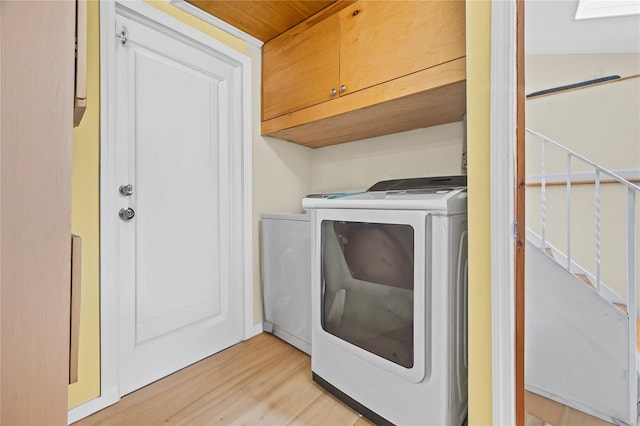 211 Cantiague Rock Rd, Westbury, NY 11590 - laundry area with washing machine and clothes dryer, light wood-style flooring, and cabinet space