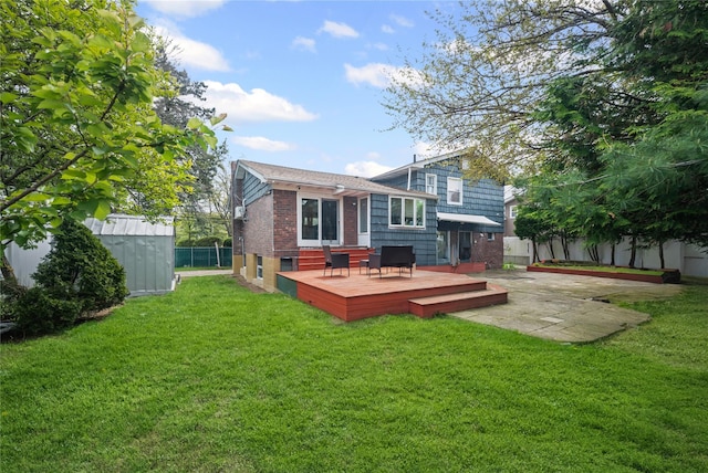211 Cantiague Rock Rd, Westbury, NY 11590 - rear view of house with a deck, brick siding, a storage unit, a yard, and a fenced backyard