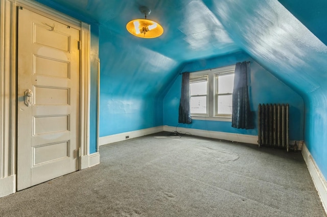 84-52 123rd St, Kew Gardens, NY 11415 - bonus room with radiator heating unit, carpet, lofted ceiling, and baseboards
