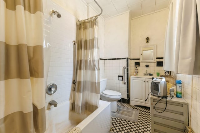 84-52 123rd St, Kew Gardens, NY 11415 - bathroom with tile walls, toilet, shower / bath combo with shower curtain, vanity, and wainscoting