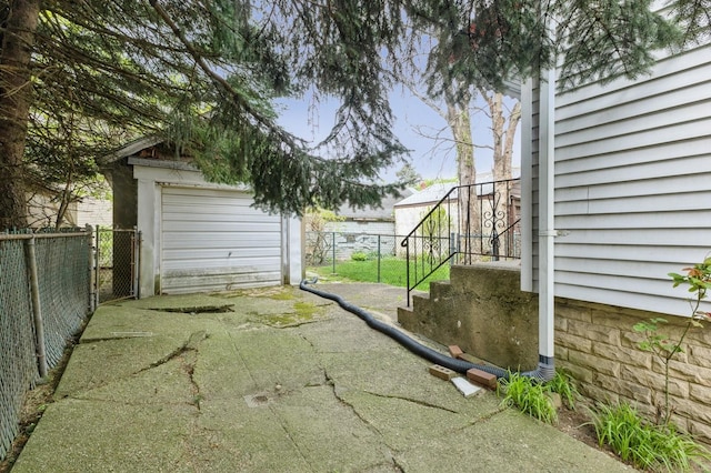 84-52 123rd St, Kew Gardens, NY 11415 - view of yard featuring driveway, fence, and an outdoor structure