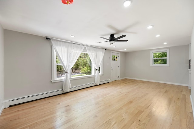 empty room featuring recessed lighting, ceiling fan, baseboard heating, wood finished floors, and baseboards