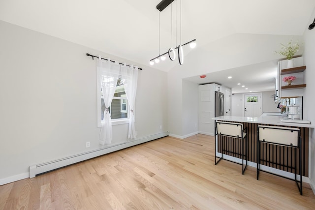 dining area featuring a baseboard heating unit, light wood-type flooring, baseboards, recessed lighting, and high vaulted ceiling