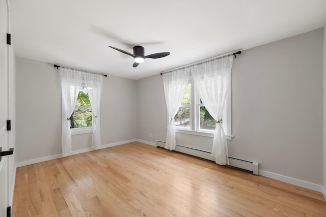 unfurnished room featuring healthy amount of natural light, light wood-type flooring, ceiling fan, and a baseboard heating unit
