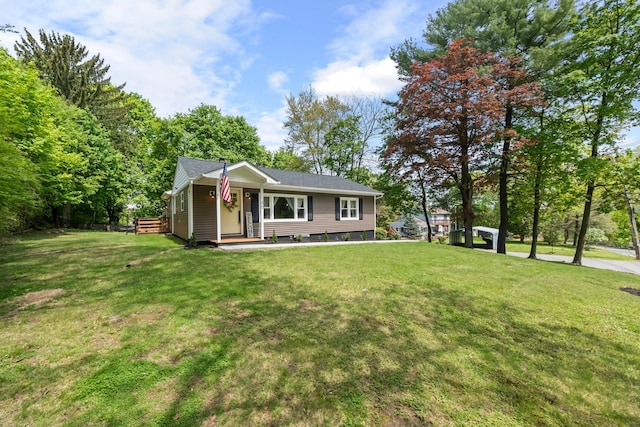 view of front of home with a front lawn and roof with shingles