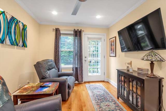 living room featuring wood finished floors, ceiling fan, ornamental molding, baseboards, and recessed lighting