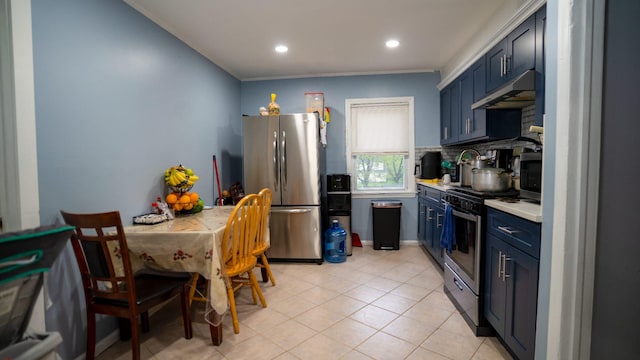 kitchen featuring light countertops, under cabinet range hood, backsplash, light tile patterned floors, and stainless steel appliances
