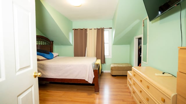 bedroom with light wood-style floors and baseboards