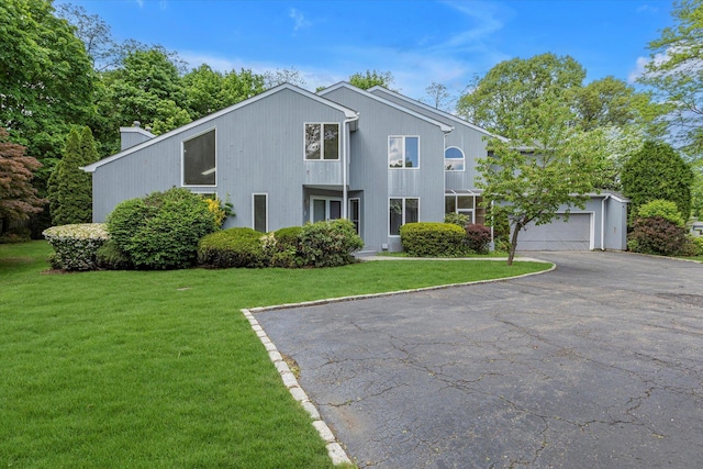 2 Heiko Ct, Northport, NY 11768 - view of front of home with driveway, a front lawn, a chimney, and an attached garage