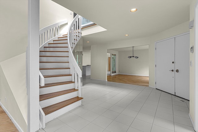 2 Heiko Ct, Northport, NY 11768 - entrance foyer with recessed lighting, stairway, light tile patterned floors, and baseboards
