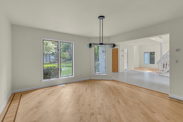 2 Heiko Ct, Northport, NY 11768 - unfurnished dining area with baseboards, wood finished floors, healthy amount of natural light, and stairway