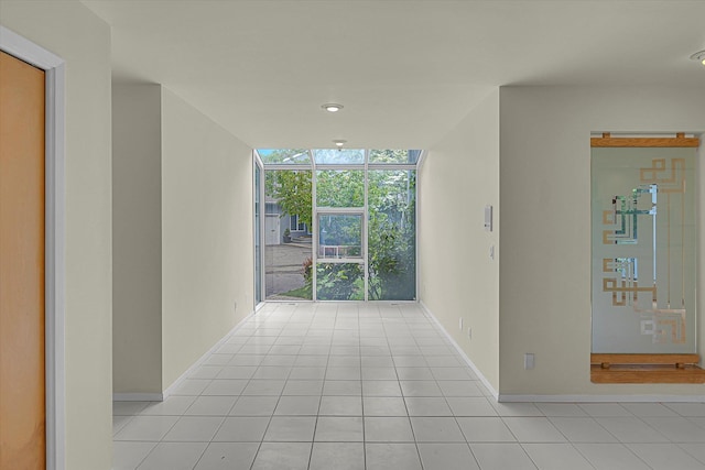 2 Heiko Ct, Northport, NY 11768 - hall featuring baseboards, light tile patterned floors, a wall of windows, and recessed lighting