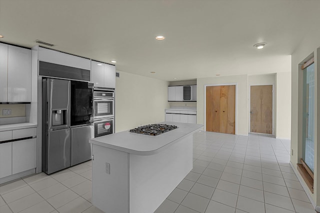 2 Heiko Ct, Northport, NY 11768 - kitchen with appliances with stainless steel finishes, light countertops, light tile patterned floors, white cabinets, and modern cabinets