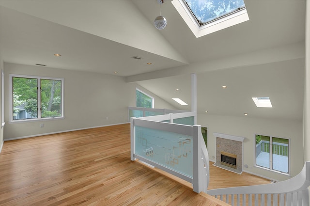2 Heiko Ct, Northport, NY 11768 - interior space with a skylight, high vaulted ceiling, plenty of natural light, light wood-type flooring, and baseboards