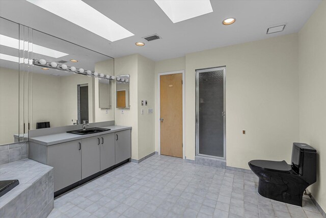 2 Heiko Ct, Northport, NY 11768 - full bathroom with a skylight, a shower stall, vanity, baseboards, and recessed lighting