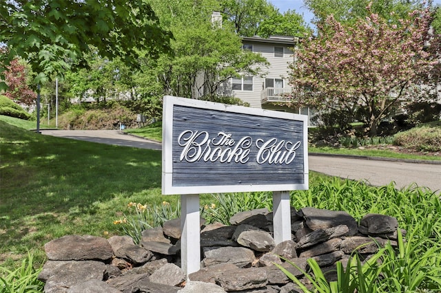 community sign featuring a lawn
