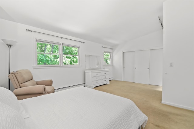 bedroom featuring baseboard heating, a closet, lofted ceiling, and light colored carpet