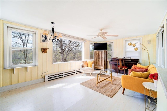 sitting room with a baseboard radiator, a ceiling fan, and wood finished floors