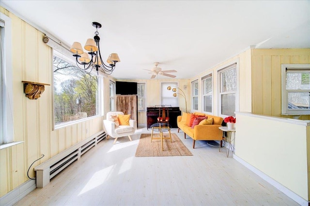 interior space featuring an inviting chandelier, wood finished floors, and a baseboard radiator