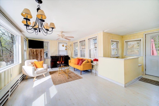 interior space with an inviting chandelier, wood finished floors, and a baseboard radiator