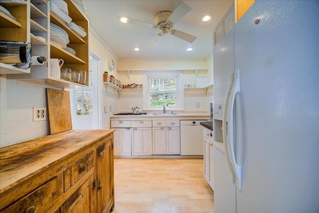 kitchen with crown molding, open shelves, white appliances, wooden counters, and a sink