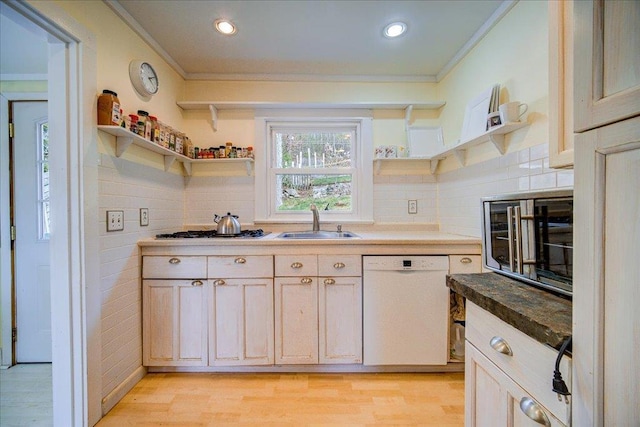 kitchen featuring white dishwasher, open shelves, ornamental molding, and a sink