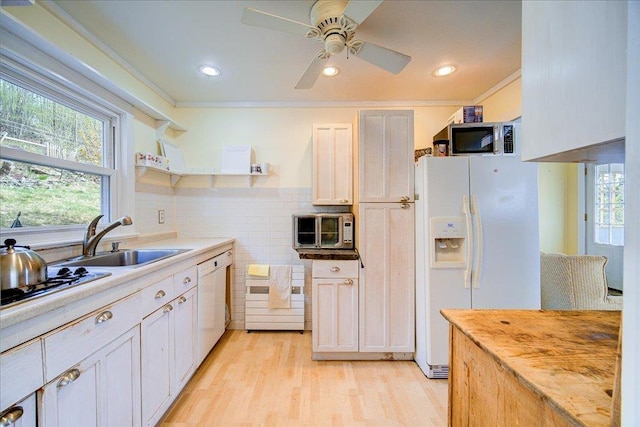kitchen featuring open shelves, ceiling fan, a sink, white appliances, and light wood-style flooring