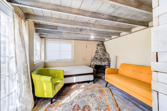 sitting room with wood finished floors, wooden ceiling, and beamed ceiling