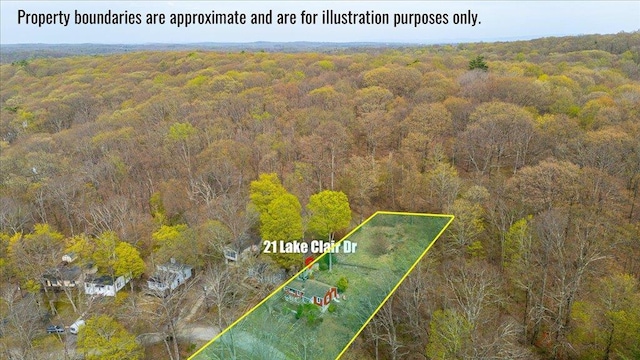 drone / aerial view featuring a wooded view