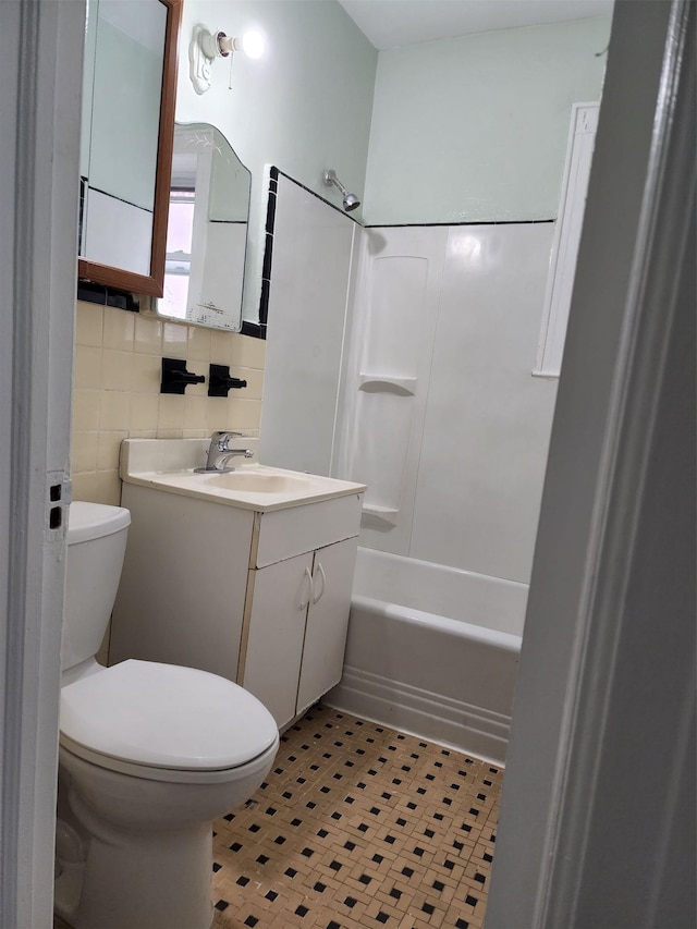 full bathroom featuring vanity, washtub / shower combination, and toilet