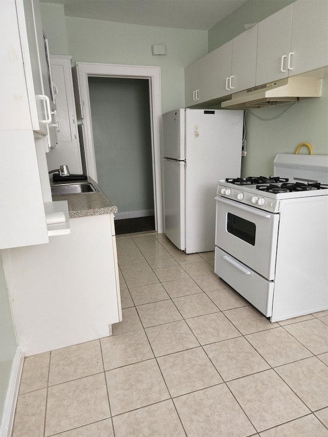 kitchen featuring a sink, light tile patterned floors, under cabinet range hood, and white appliances