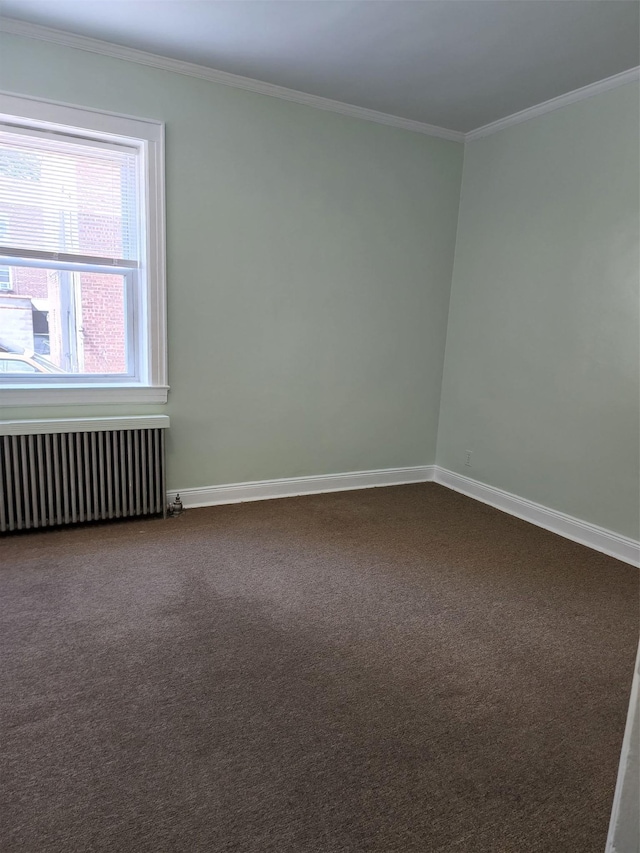 empty room with crown molding, radiator, dark carpet, and baseboards