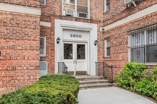 doorway to property with brick siding and french doors