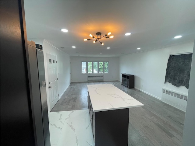 188-51 120th Rd, Saint Albans, NY 11412 - unfurnished living room with radiator heating unit, crown molding, recessed lighting, a chandelier, and baseboards