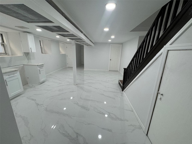 188-51 120th Rd, Saint Albans, NY 11412 - finished basement featuring baseboards, stairs, light marble finish flooring, and recessed lighting