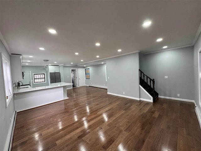 188-51 120th Rd, Saint Albans, NY 11412 - unfurnished living room with ornamental molding, stairs, a baseboard radiator, a sink, and dark wood-style flooring
