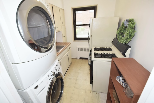 laundry area featuring laundry area, radiator heating unit, and stacked washer and clothes dryer