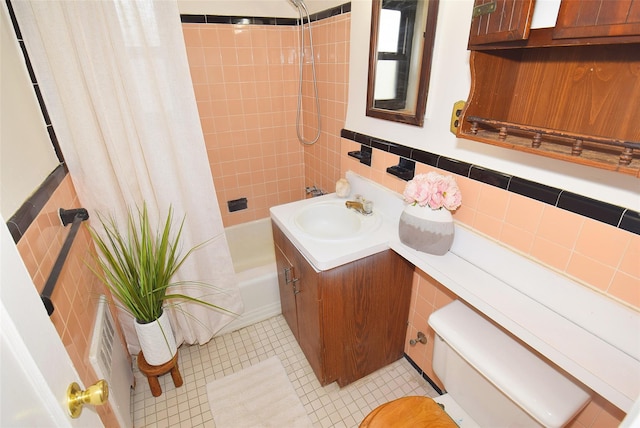 bathroom featuring vanity, toilet, and shower / bath combo with shower curtain