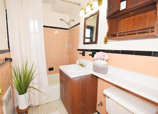 bathroom with visible vents, tile walls, vanity, toilet, and shower / bathtub combination with curtain